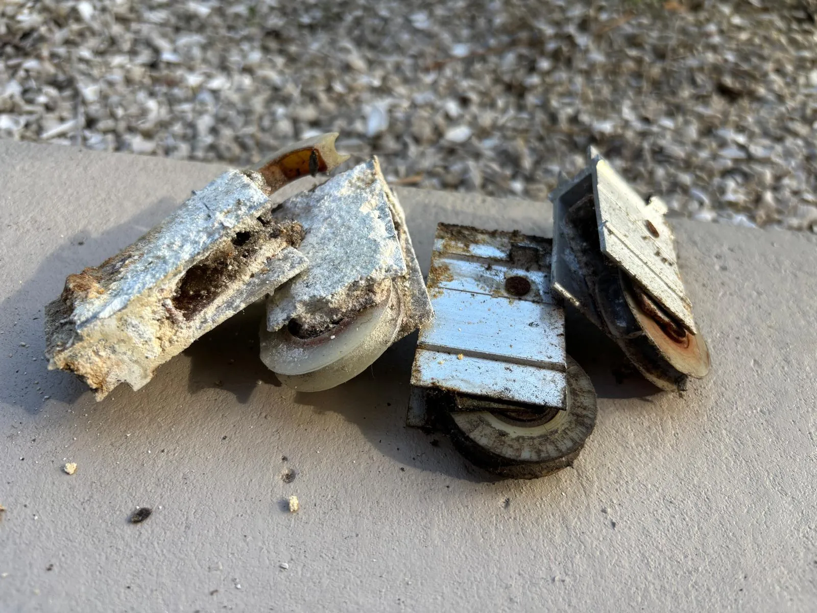 Damaged vs new sliding door rollers closeup