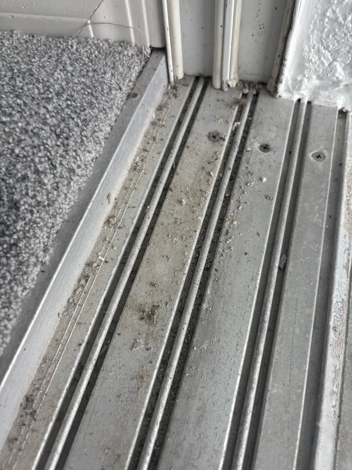 Technician cleaning sliding door track