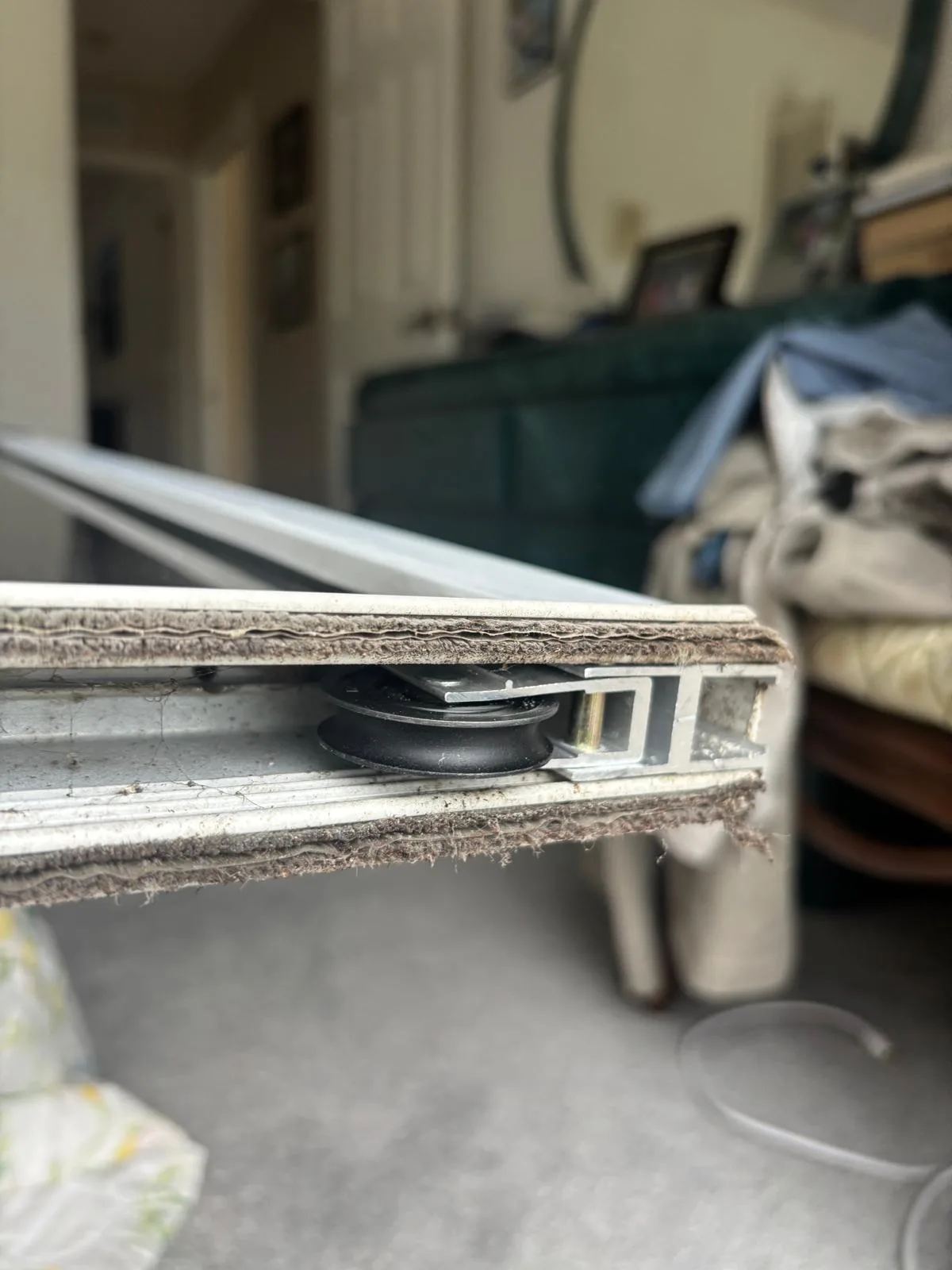 Inspecting sliding door roller during maintenance